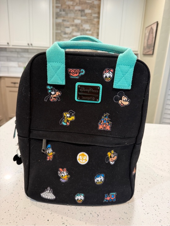 black disney loungefly mini backpack Mickey Constellation AOP Glow in the Dark Exclusive! Bag has adjustable shoulder straps and gunmetal Disney Loungefly Darth Vader Light-up